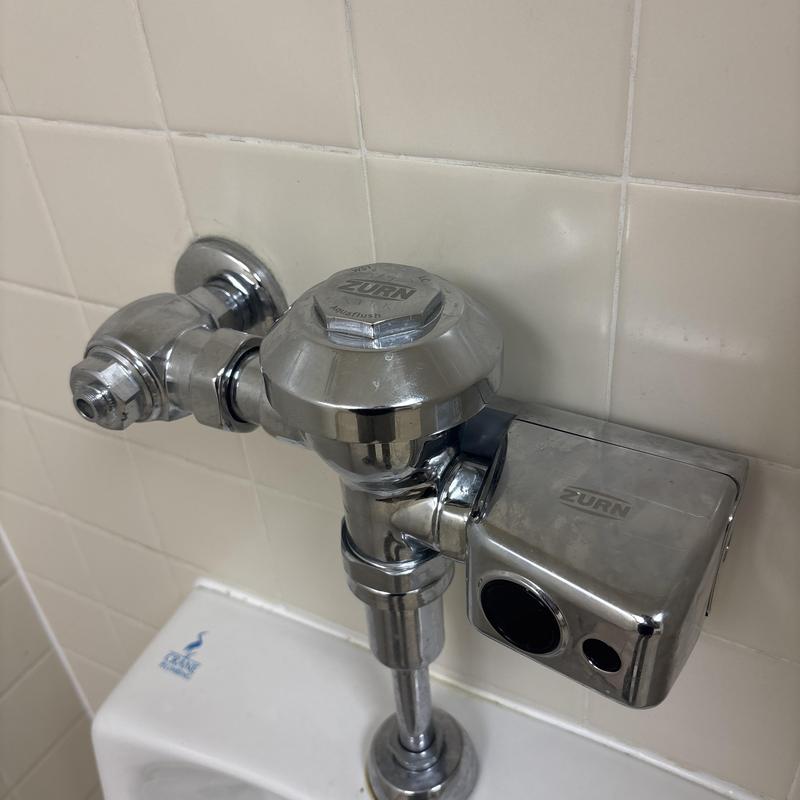 Flushometer valve with sensor on restroom urinal Flushometer valve with sensor on restroom urinal