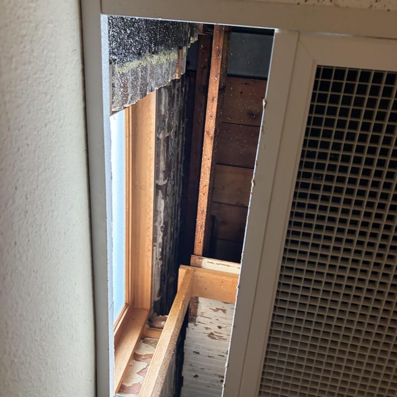 Flat roof interior beams and water damage near window
