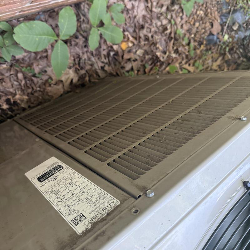 Air conditioner unit exterior with vent and label Air conditioner unit exterior with vent and label