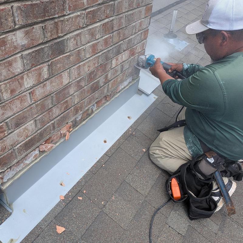 Chimney flashing grinding on asphalt roof shingles