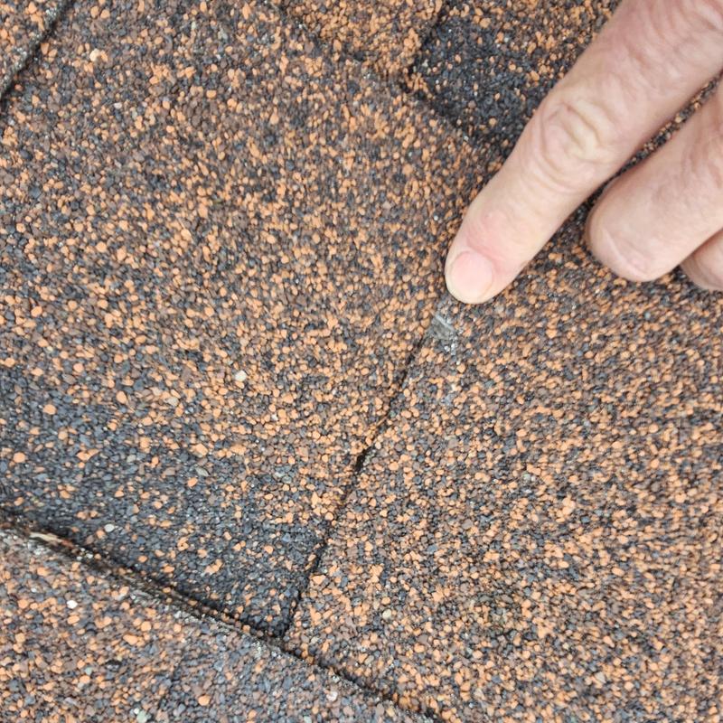 Asphalt shingle roof with hail damage crack