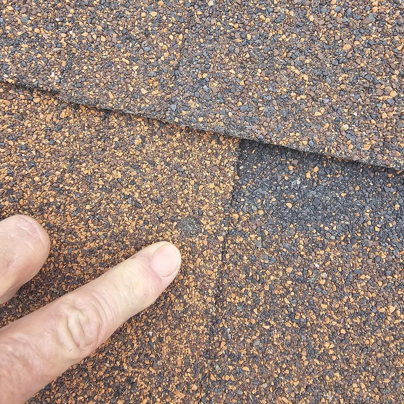 Asphalt shingle roof with hail damage close-up