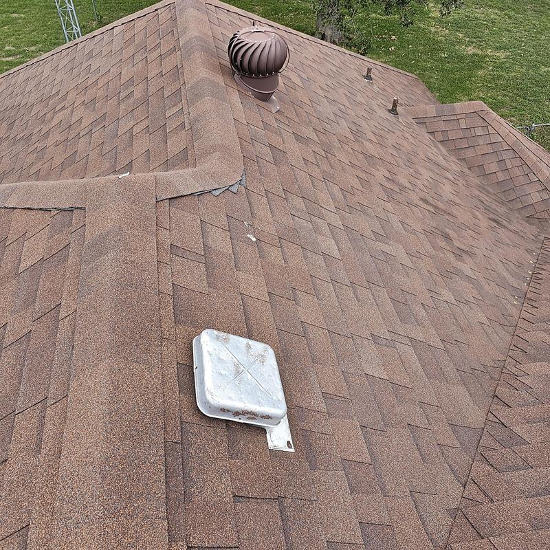Asphalt shingle roof with wind and hail damage
