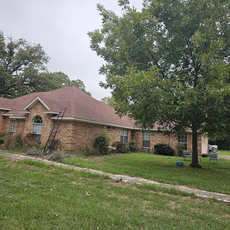 Asphalt shingle roof with ladder for storm damage inspection