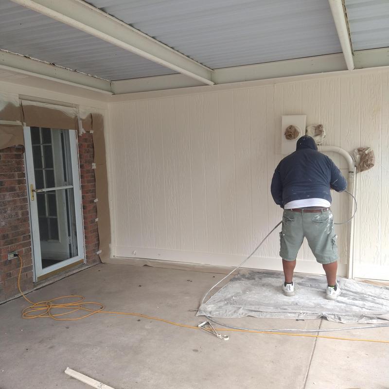 Outdoor wall panel painting with protective coverings