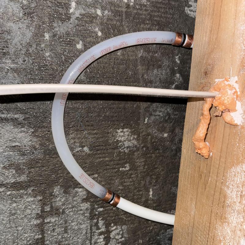 Pex water line with copper fittings inside wall cavity Pex water line with copper fittings inside wall cavity