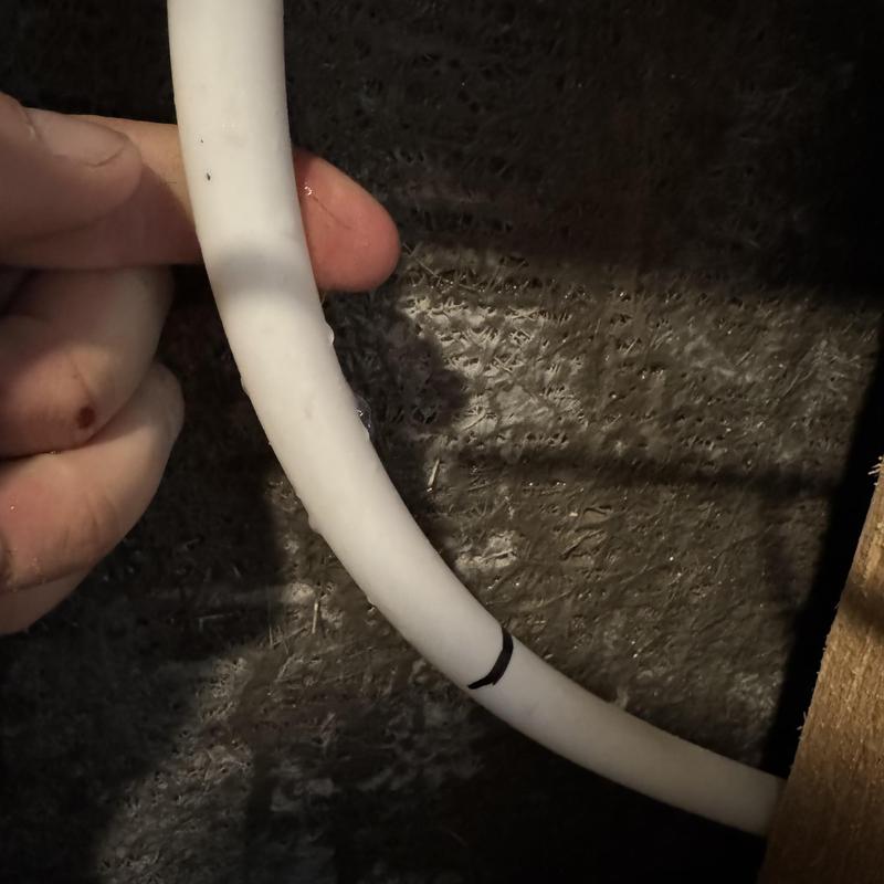 Hot water PEX pipe with visible split leak in wall cavity Hot water PEX pipe with visible split leak in wall cavity