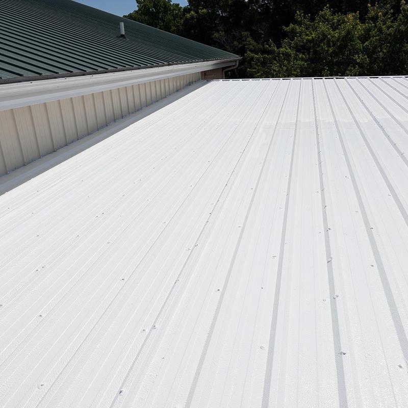 Commercial metal roof with elastomeric coating