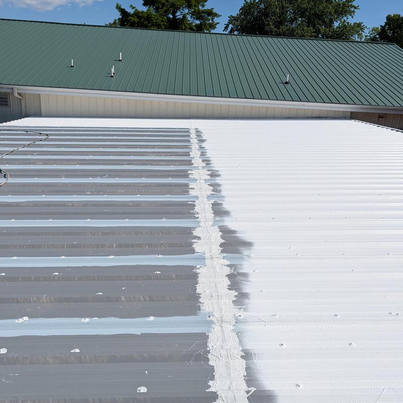 Commercial metal roof with elastomeric restoration coating
