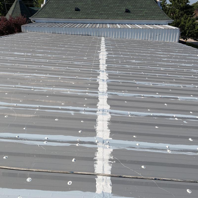 Commercial metal roof with sealed fasteners and seams