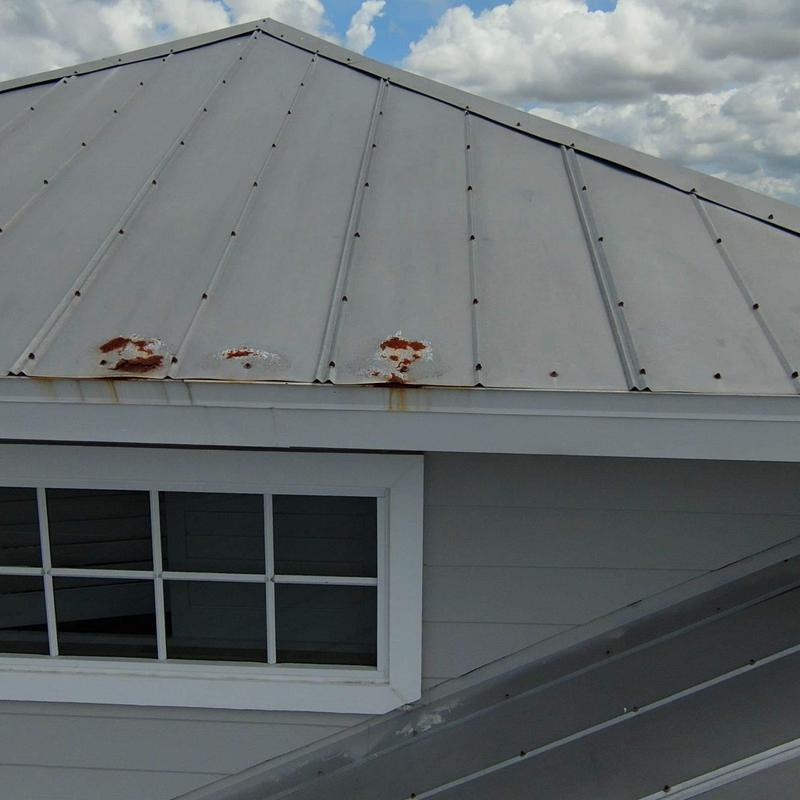 Metal roof panels with rust and corrosion damage Metal roof panels with rust and corrosion damage