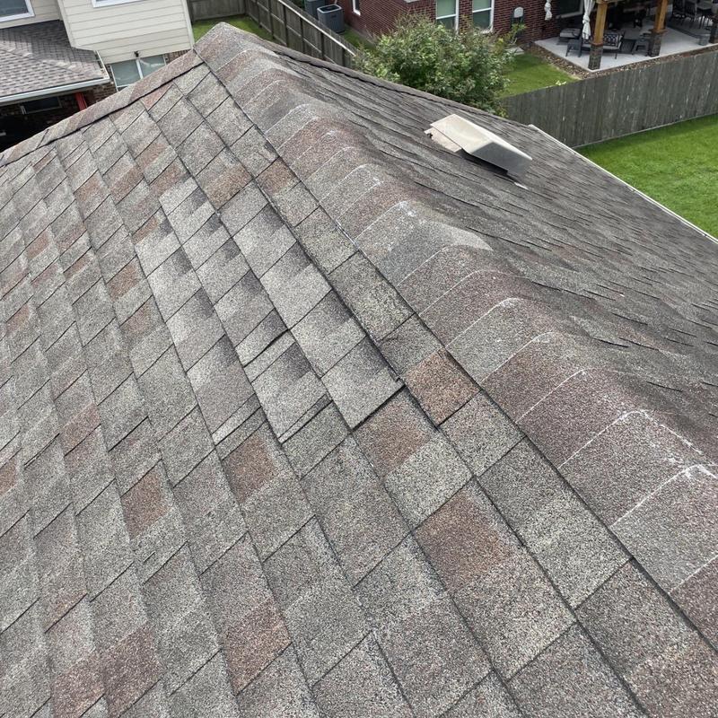 Architectural shingles on residential roof ridge in Pearland TX