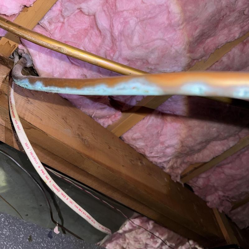 Copper water pipe with visible corrosion in attic space Copper water pipe with visible corrosion in attic space