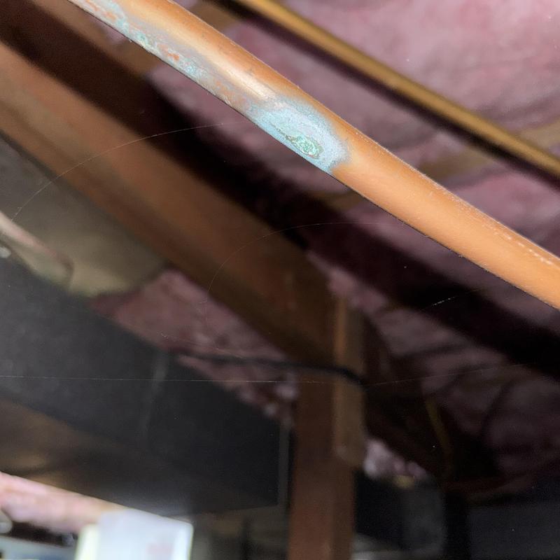 Copper pipe with corrosion in attic space Copper pipe with corrosion in attic space