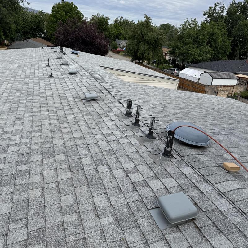 Asphalt shingle roof with vents and satellite dish installation Asphalt shingle roof with vents and satellite dish installation