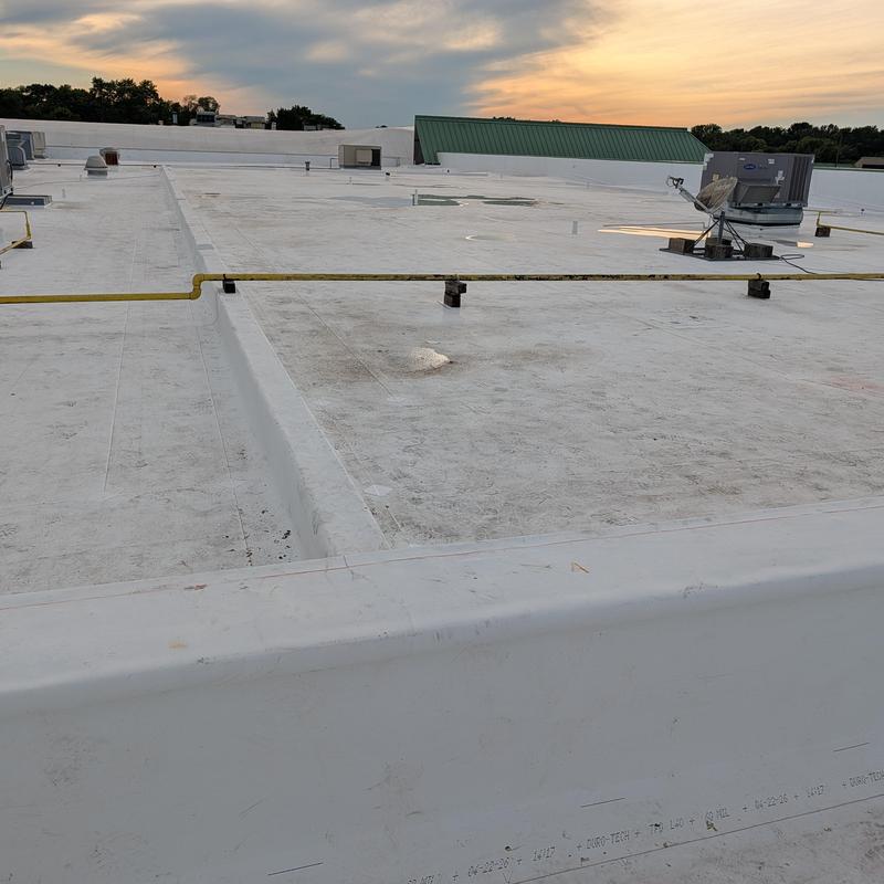 TPO single ply flat commercial roof restoration at sunset