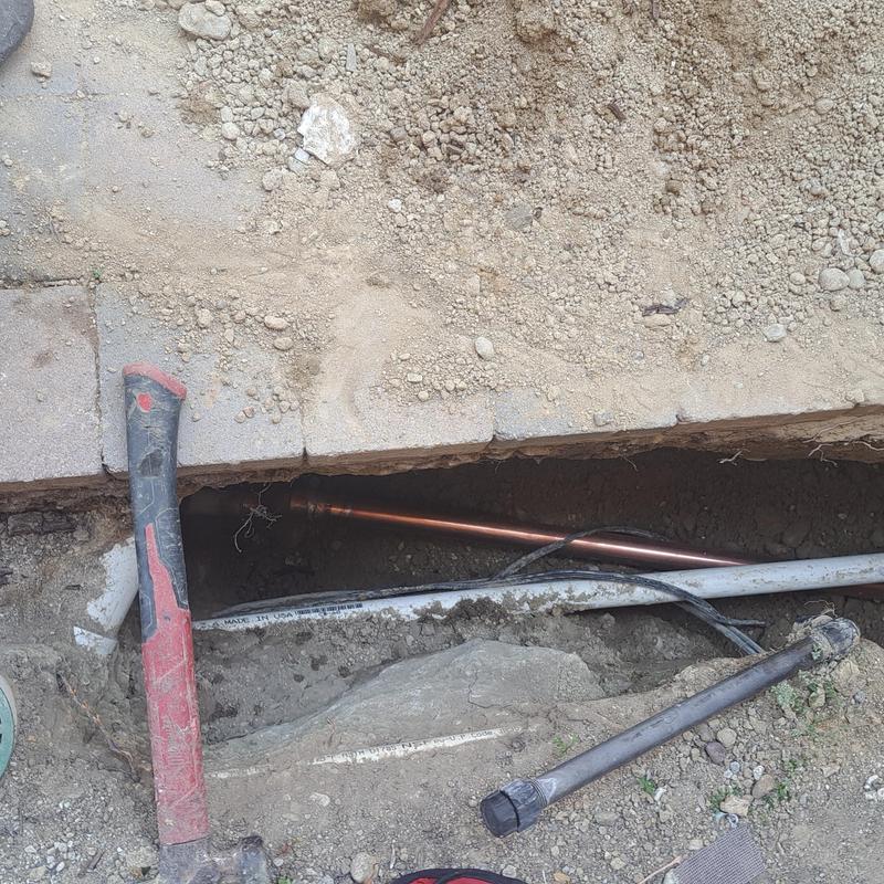 Copper water main pipe in underground trench repair Copper water main pipe in underground trench repair
