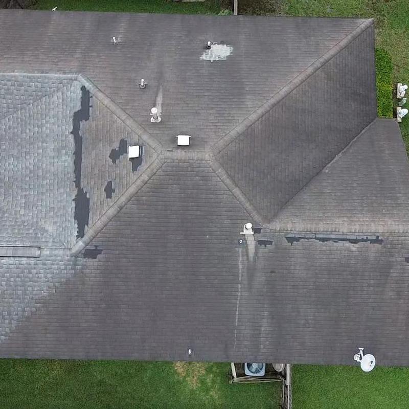 Shingle roof with visible wear and patch areas