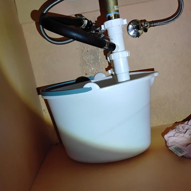 Bathroom sink drain pipes disassembled for clog clearing