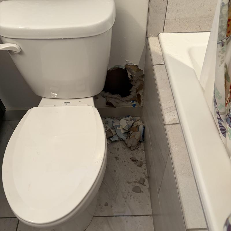 Toilet supply line leak with wall damage and debris Toilet supply line leak with wall damage and debris