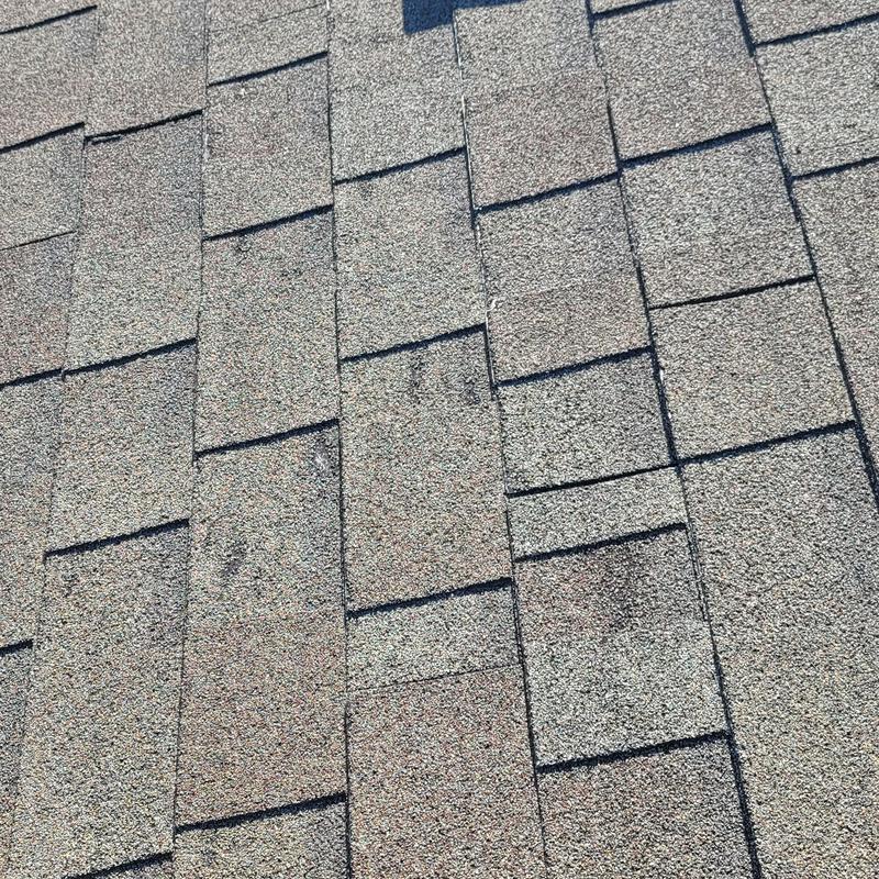 Roof shingles with visible hail damage marks
