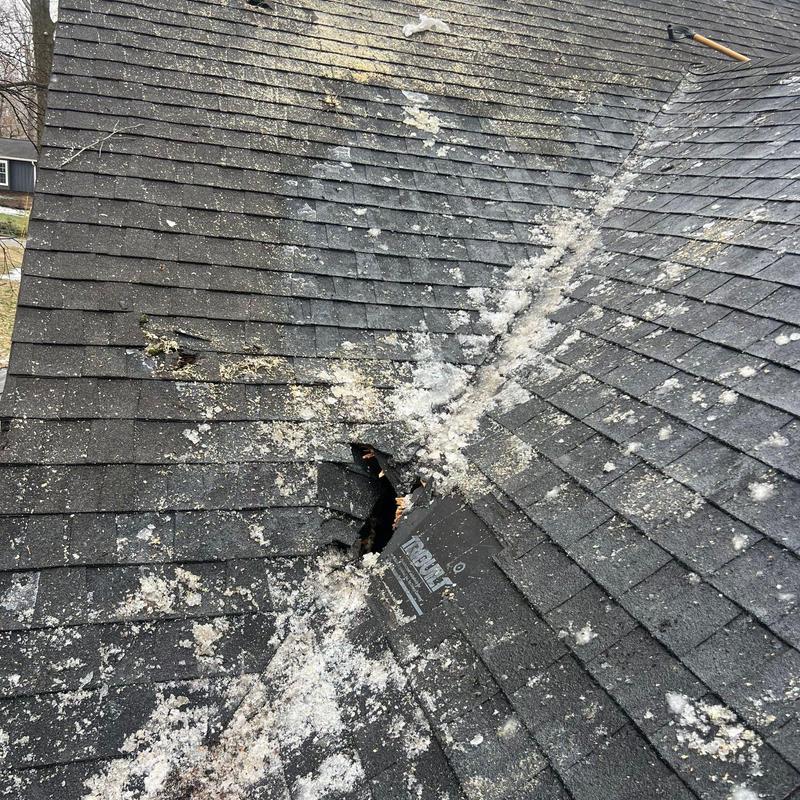 Asphalt shingles with hail damage and puncture hole