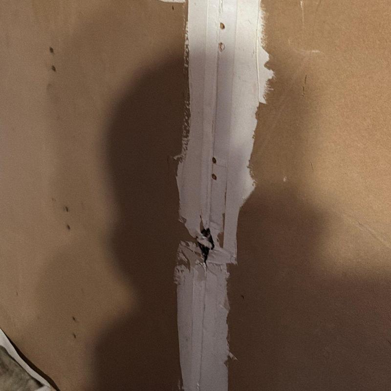 Drywall joint with visible crack and damage