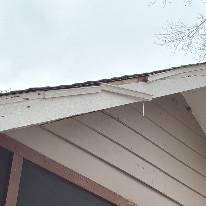 Roof shingles and fascia with hail damage and wear