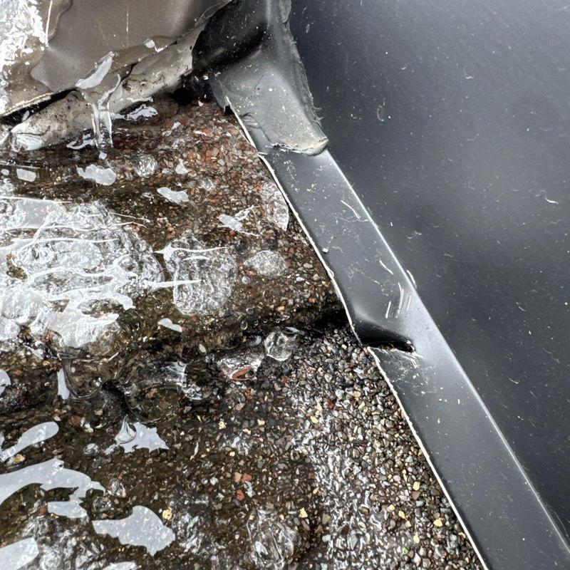 Roof flashing damage with hail impact and water pooling