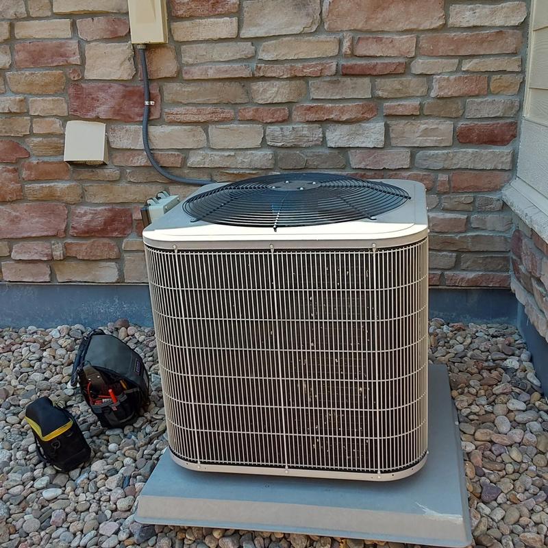 Carrier 113ANA outdoor air conditioner unit on pad