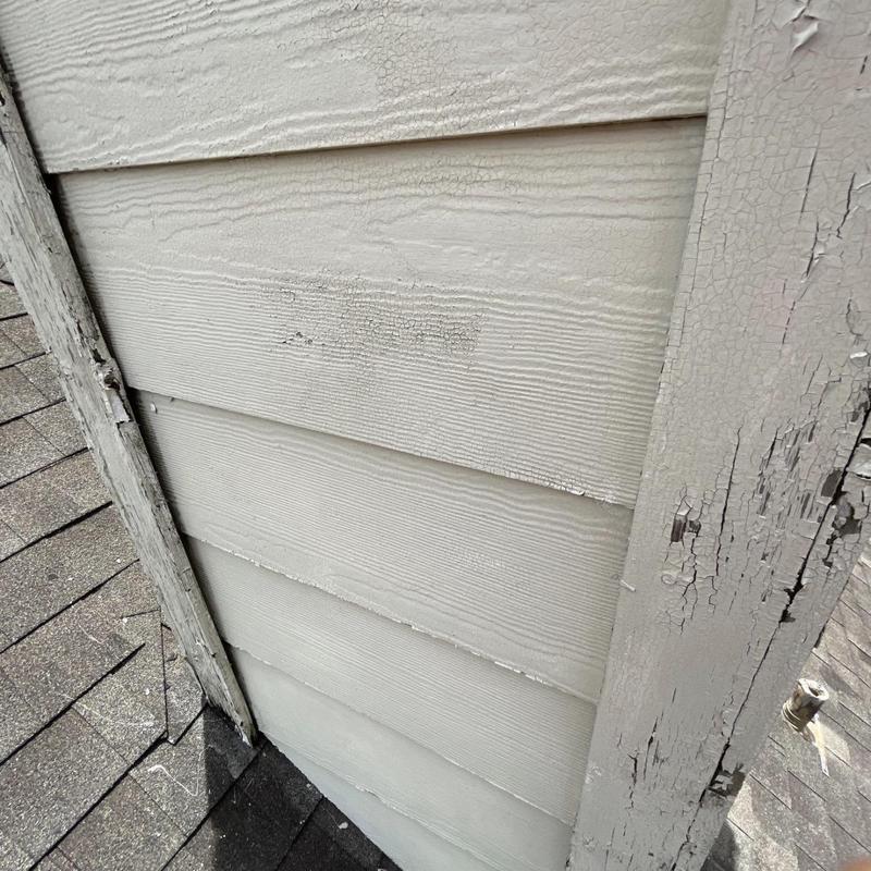 Chimney siding with wood rot and paint deterioration