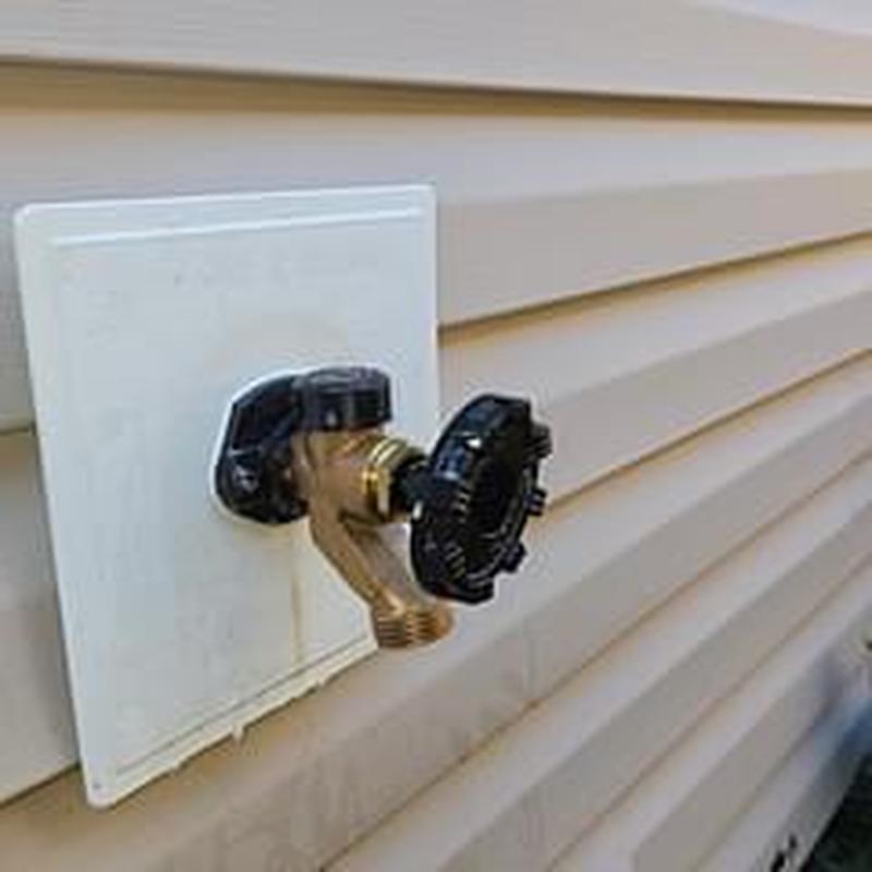 Hose bib installation with angled brass spout on siding
