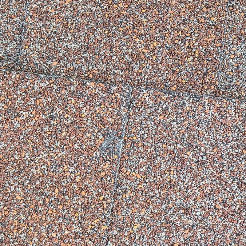 Asphalt shingle roof with hail damage close-up