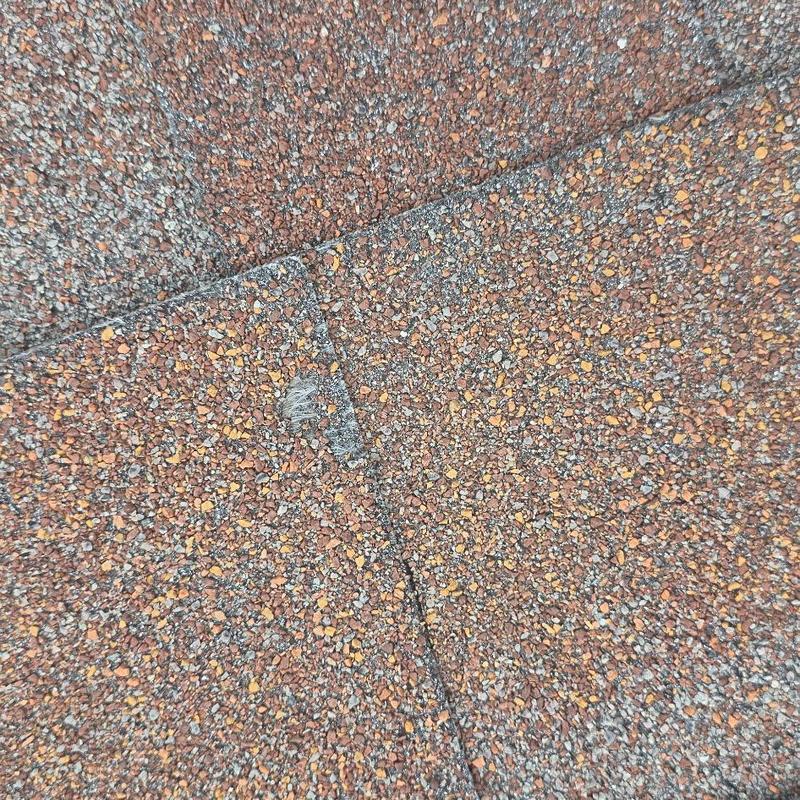 Asphalt shingle roof with hail damage close-up