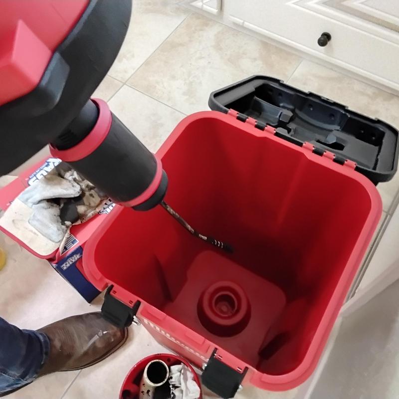 Shower drain cable clearing tool in use