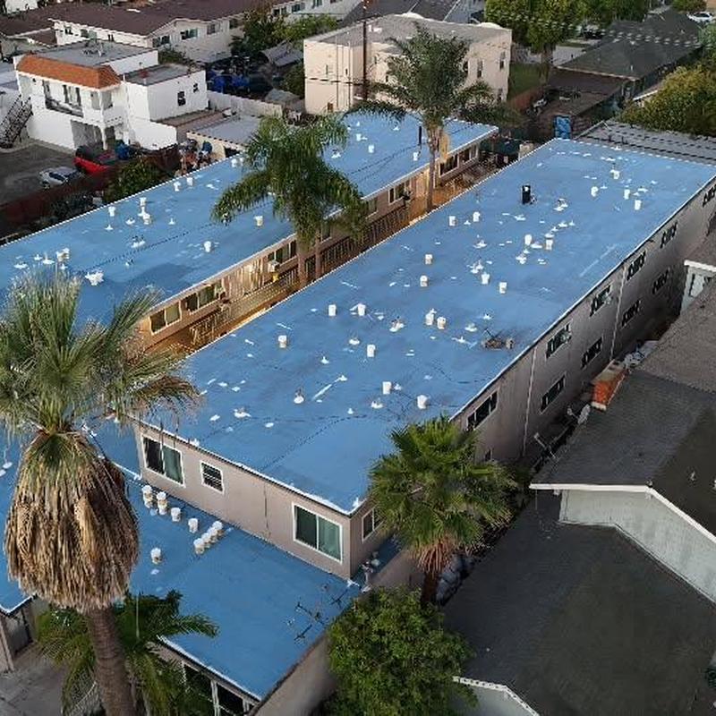 Silicone roof coating on apartment building roof Silicone roof coating on apartment building roof