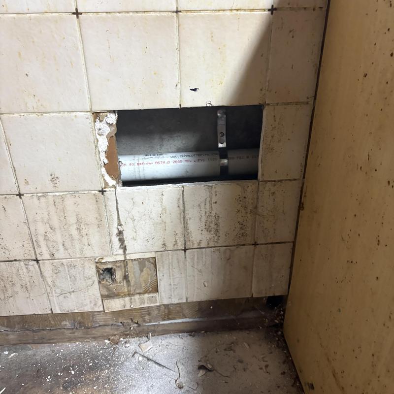 PVC drain pipe inside wall cavity with tile removal PVC drain pipe inside wall cavity with tile removal