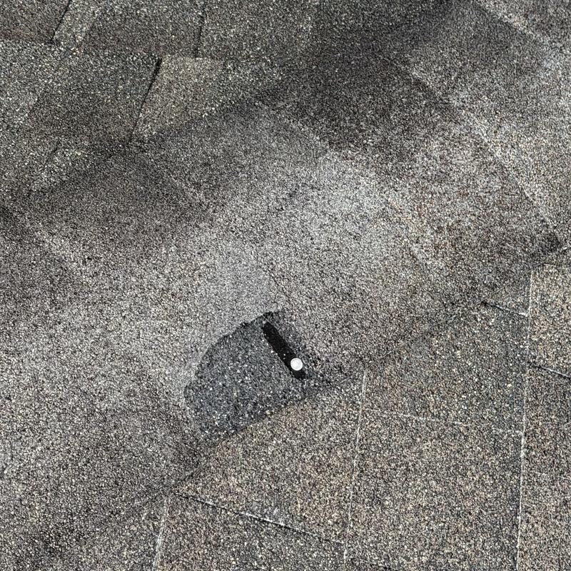 Asphalt shingle roof with nail and patch detail