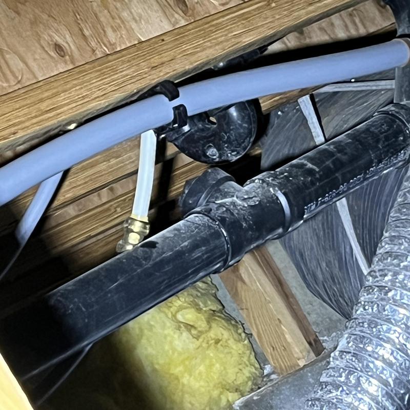 Pex A piping installation with black drain pipe above insulation Pex A piping installation with black drain pipe above insulation