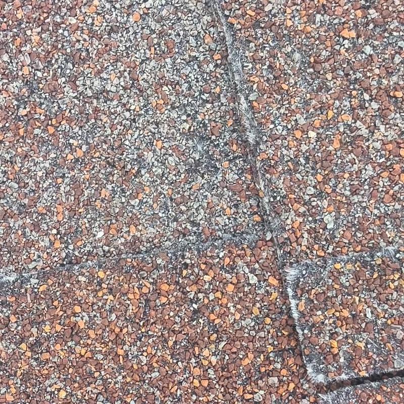 Asphalt shingle roof with hail damage close-up