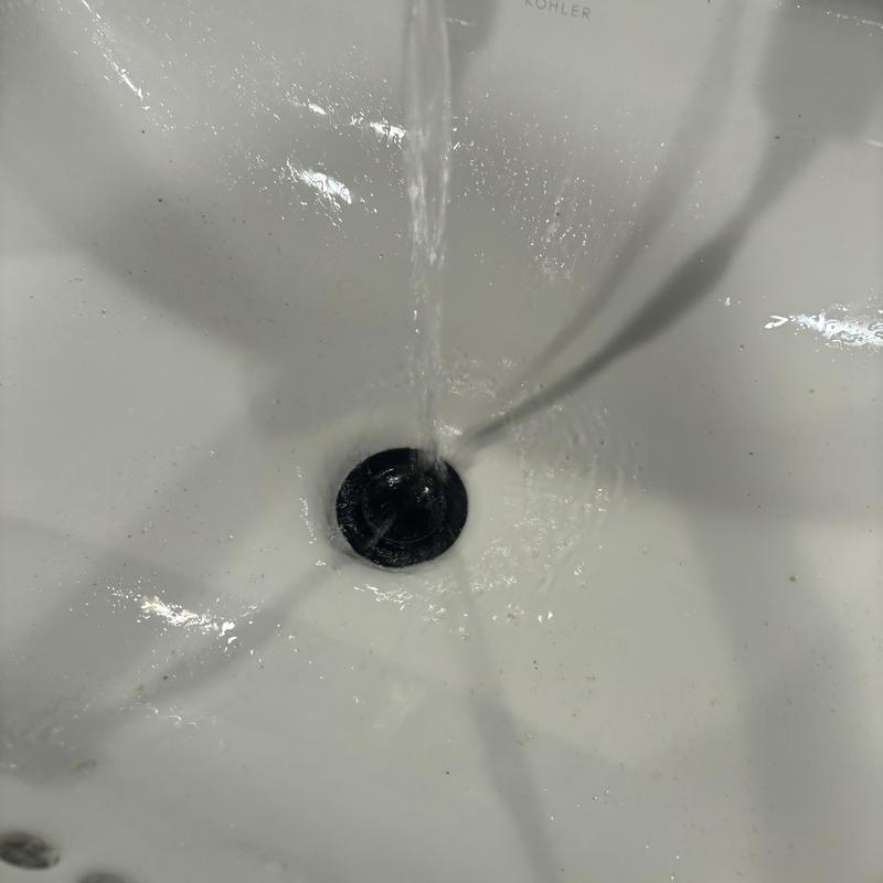 Vanity sink drain cleaning with running water