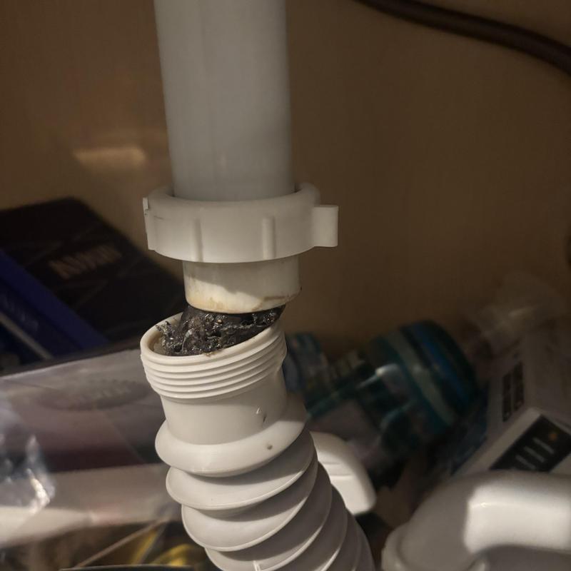 Vanity sink drain pipe with clog buildup inside