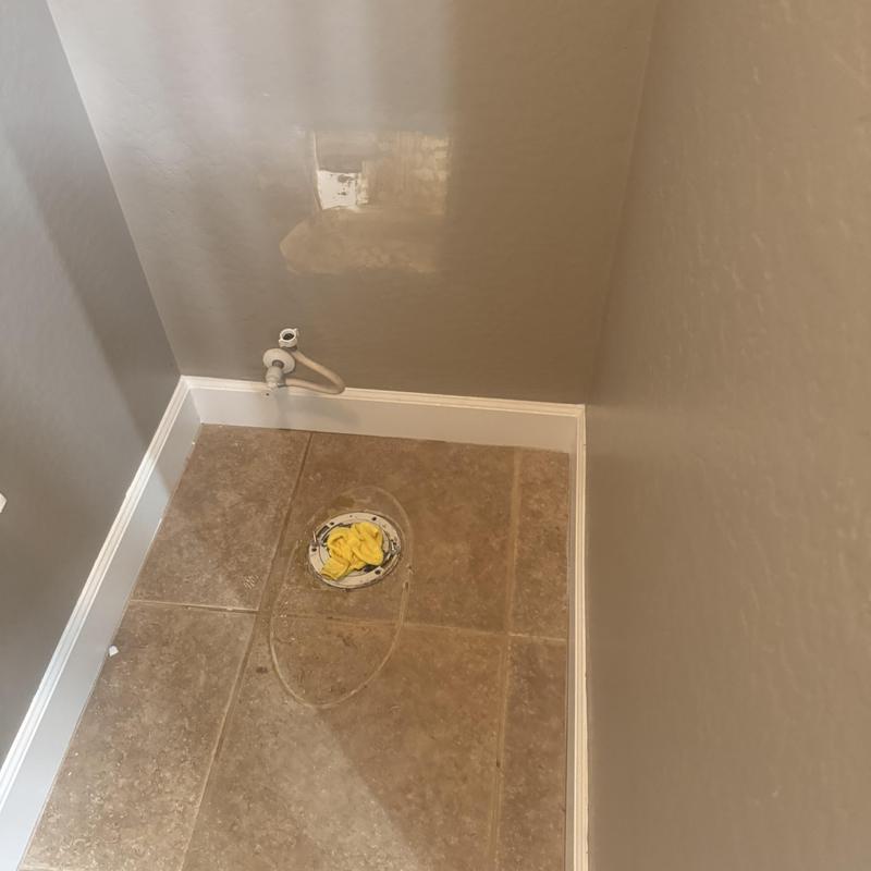 Toilet flange in bathroom floor with water supply line removed