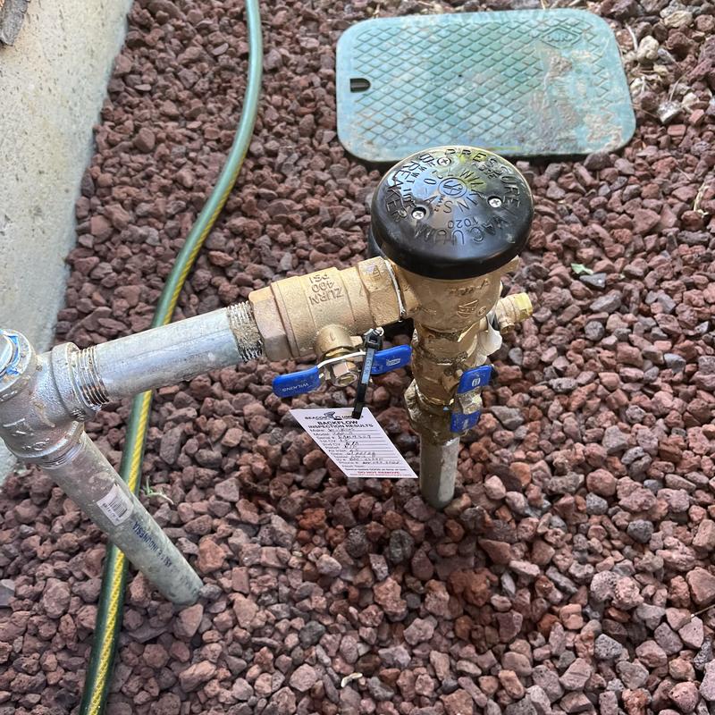 Backflow assembly with test tag on gravel bed