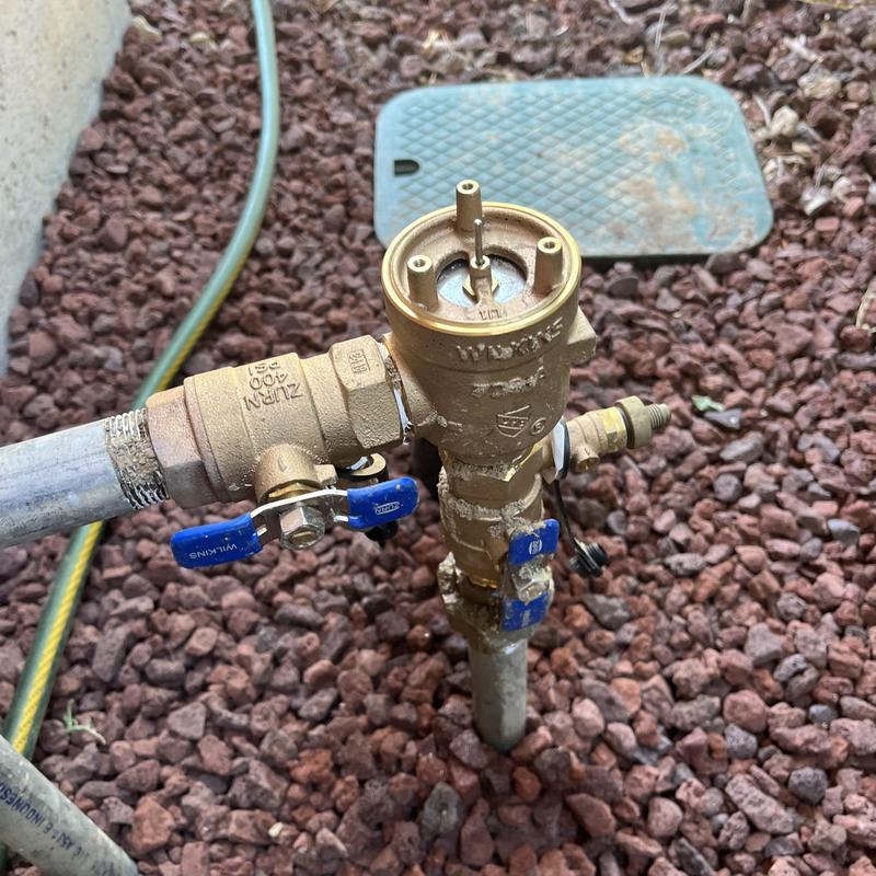 Backflow assembly valve with shut-off handles outdoors