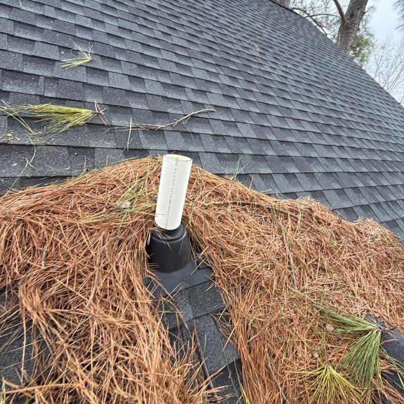 Roof vent pipe with debris on asphalt shingles
