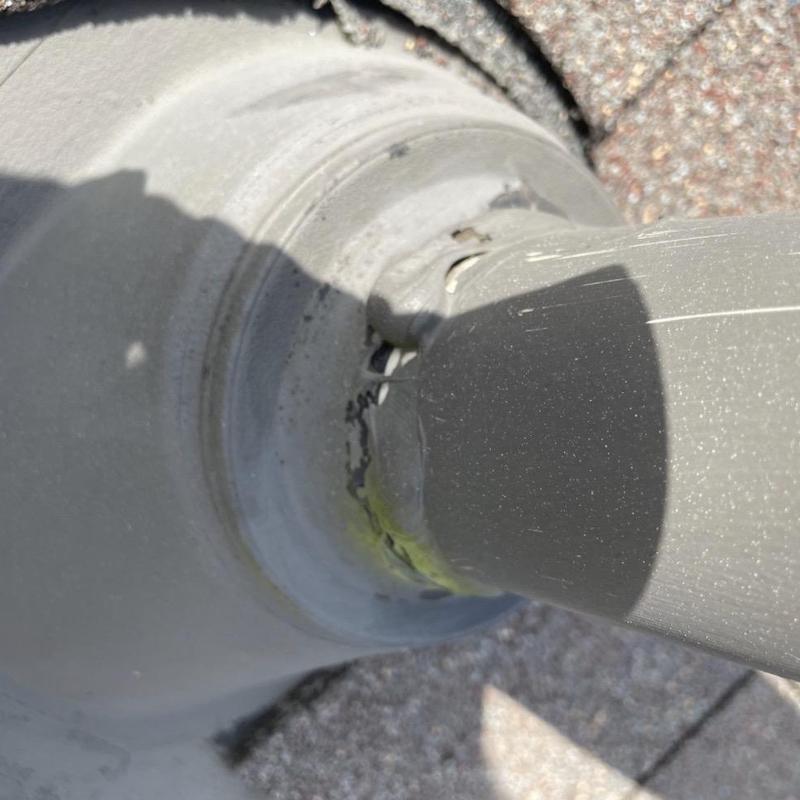 Roof pipe flashing with deteriorated sealant and damage