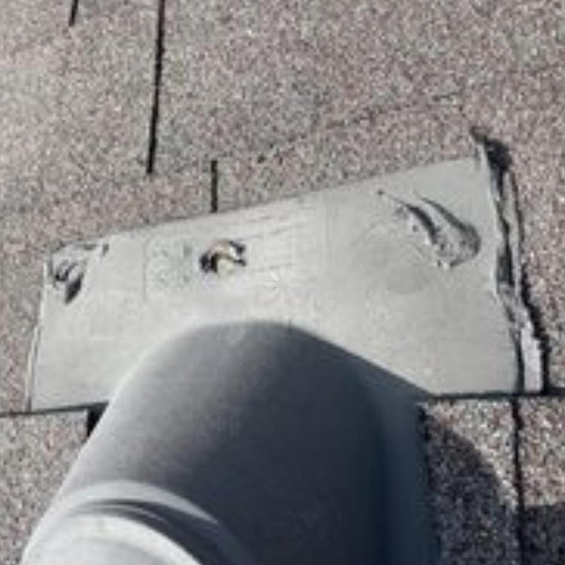 Roof vent flashing with sealant repairs on shingles
