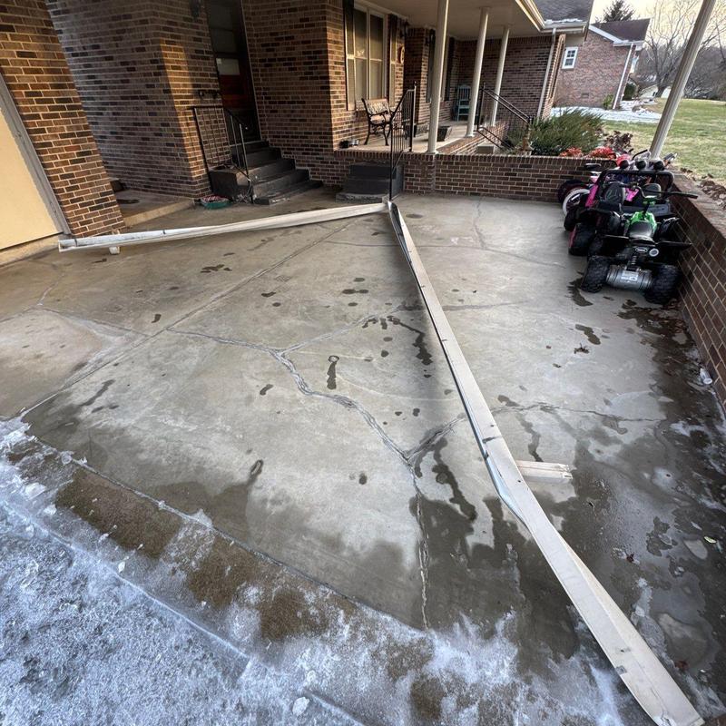 Concrete driveway with broken gutter downspouts