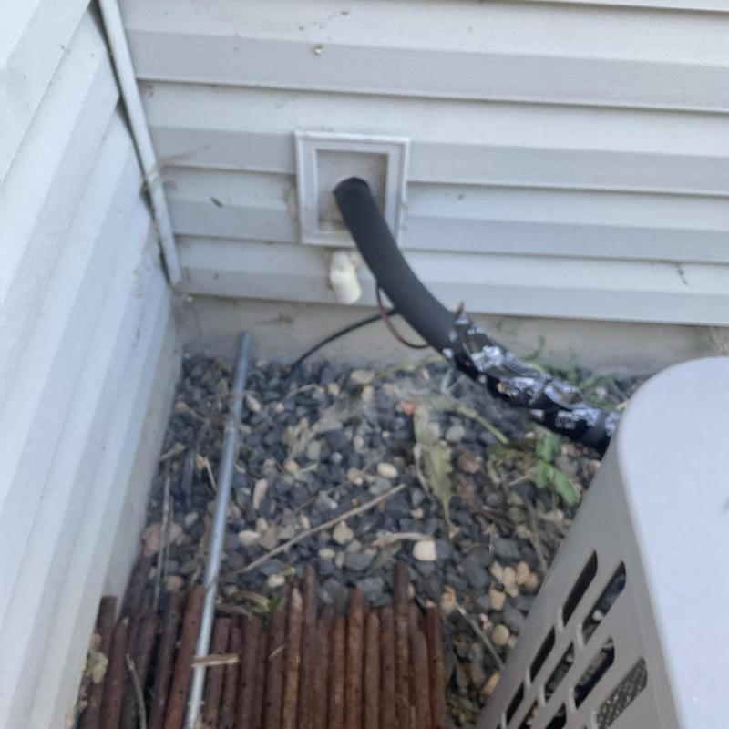 HVAC drain pipe outside house with insulation wrap HVAC drain pipe outside house with insulation wrap